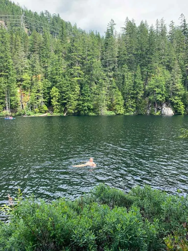 Swimming in Brohm Lake with paddleboarders in the background