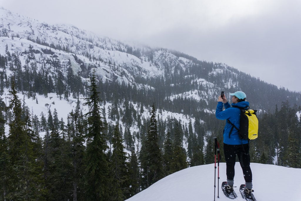 Snowshoeing at the top of the Sea to Sky Gondola in Squamish. Find out how to stay safe in the mountains in the winter with these 8 tips for winter hiking.