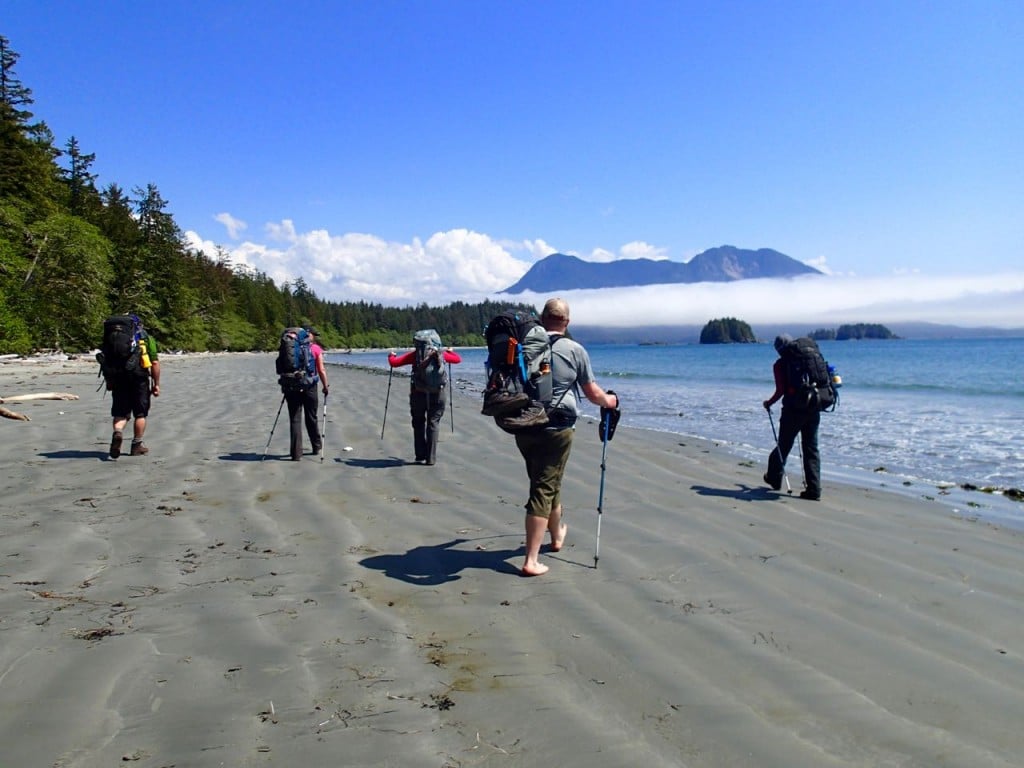 Backpackers hiking on the beach on the Wild Side Trail near Tofino