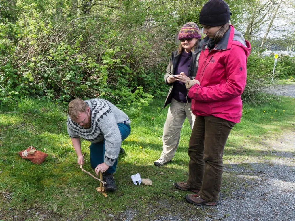 Learning to make a bow drill fire in a wilderness survival course with Megan Hanacek and Carleigh Fairchild