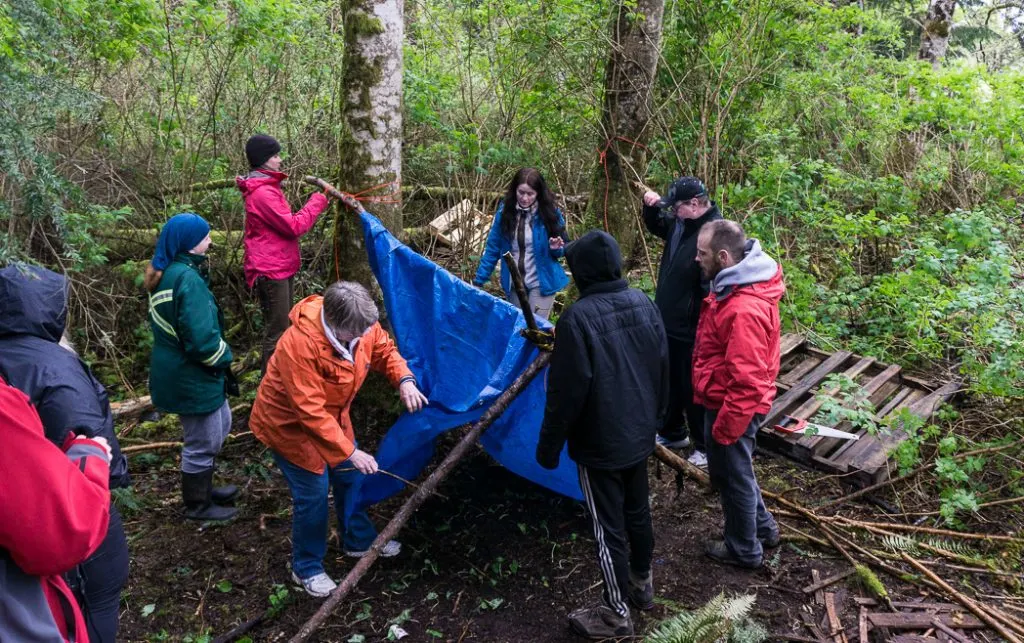 Learning to build a tarp shelter in a wilderness survival course with Megan Hanacek and Carleigh Fairchild