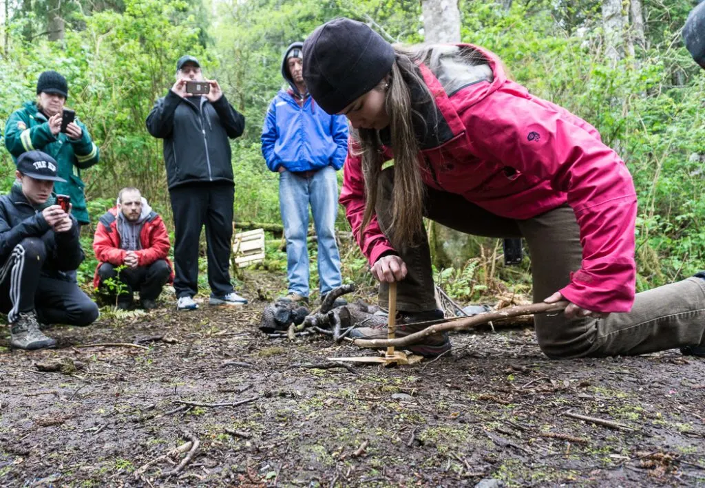 Learning to make a bow drill fire in a wilderness survival course with Megan Hanacek and Carleigh Fairchild