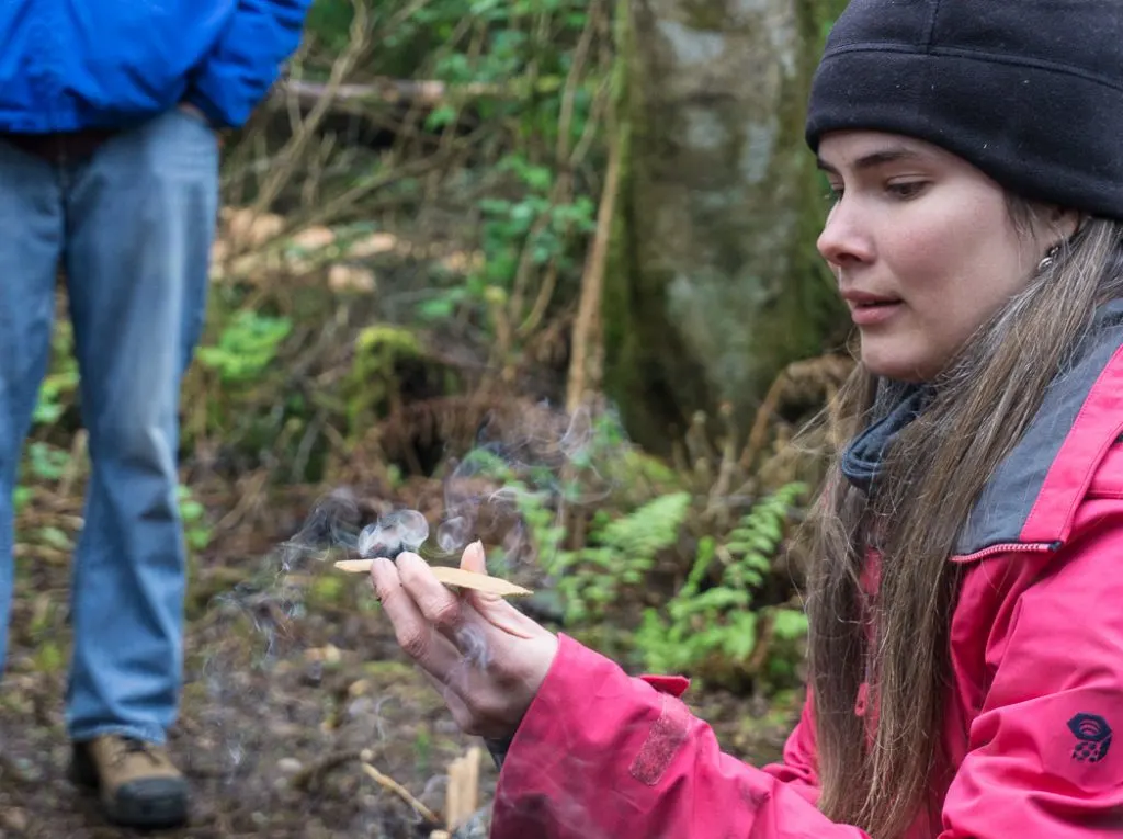 Learning to make a bow drill fire in a wilderness survival course with Megan Hanacek and Carleigh Fairchild