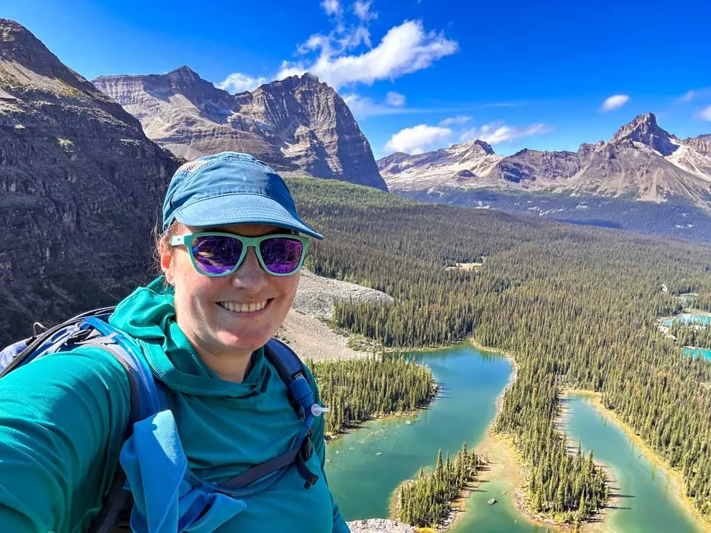 A woman takes a selfie in front of lake O'Hara in the Rockies