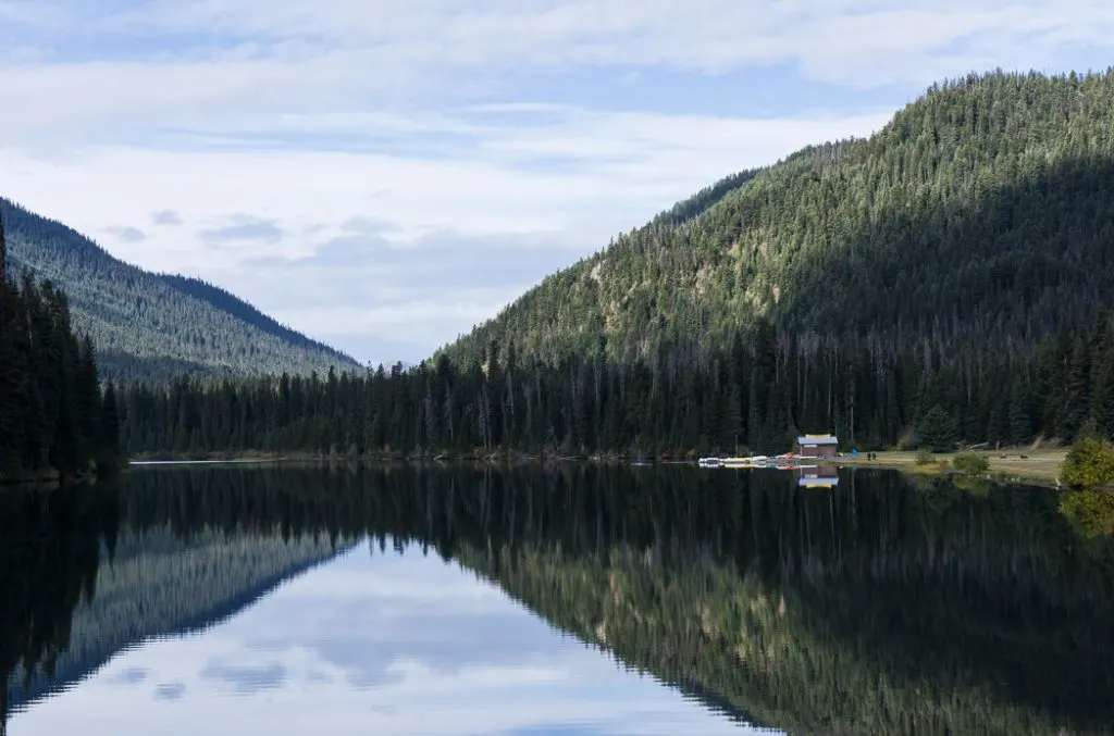 Reflections on Lightning Lake on the way to Frosty Mountain. Hike to the gorgeous Frosty Mountain larches in British Columbia, Canada. Go hiking in the fall to the see the larch trees change colour in Manning Park, BC, Canada.