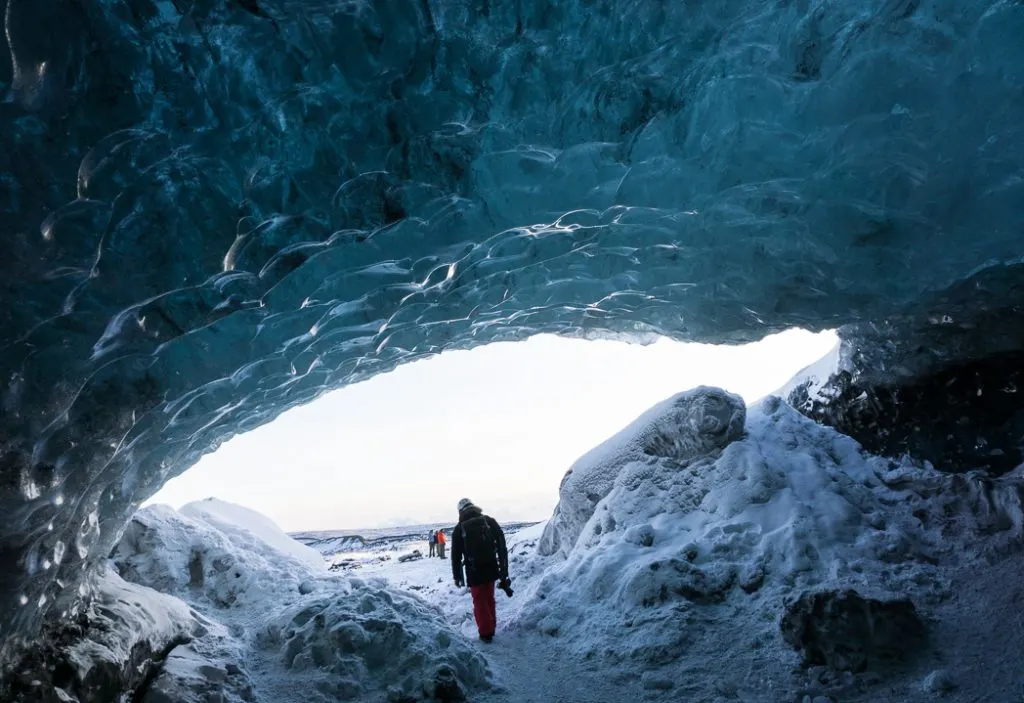 The mouth of an ice cave in Iceland. The Ultimate Guide to Ice Caves in Iceland: Everything you ever needed to know about visiting ice caves in Iceland. Find out how to go INSIDE the Crystal Cave glacier ice cave to see the blue ice.