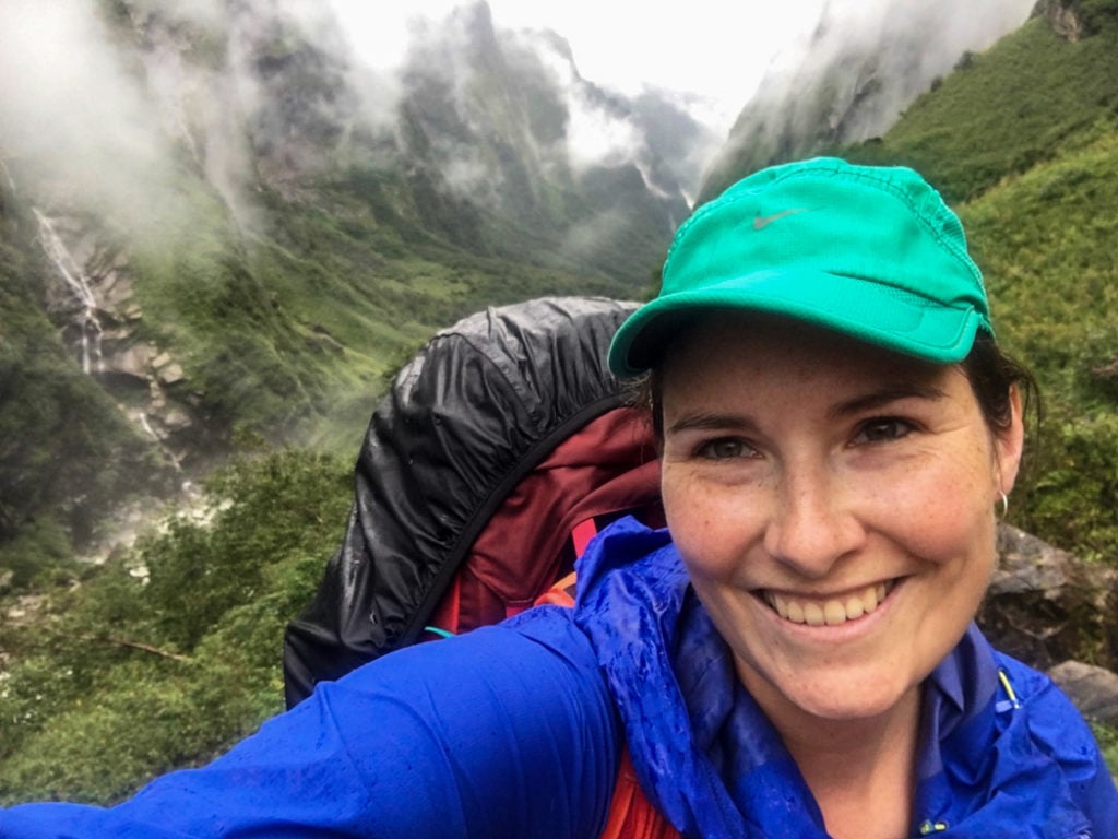 A trekker on the Annapurna Base Camp trek in the monsoon season. What to pack for the Annapurna Base Camp Trek in Nepal.