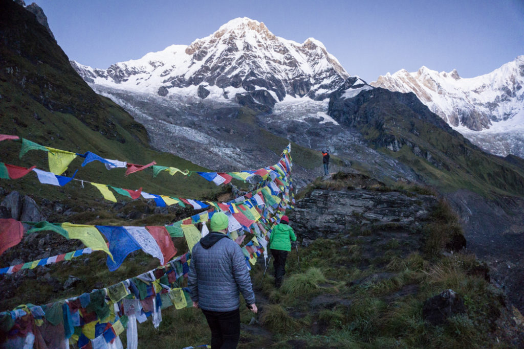 Trekkers viewing the sunrise at Annapurna Base Camp. What to pack for the Annapurna Base Camp Trek in Nepal.