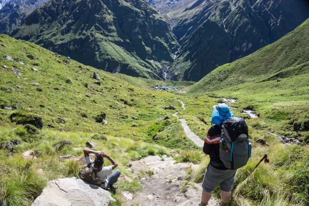 Hiker wearing a backpack near Machapuchare Base Camp. What to pack for the Annapurna Base Camp Trek in Nepal.