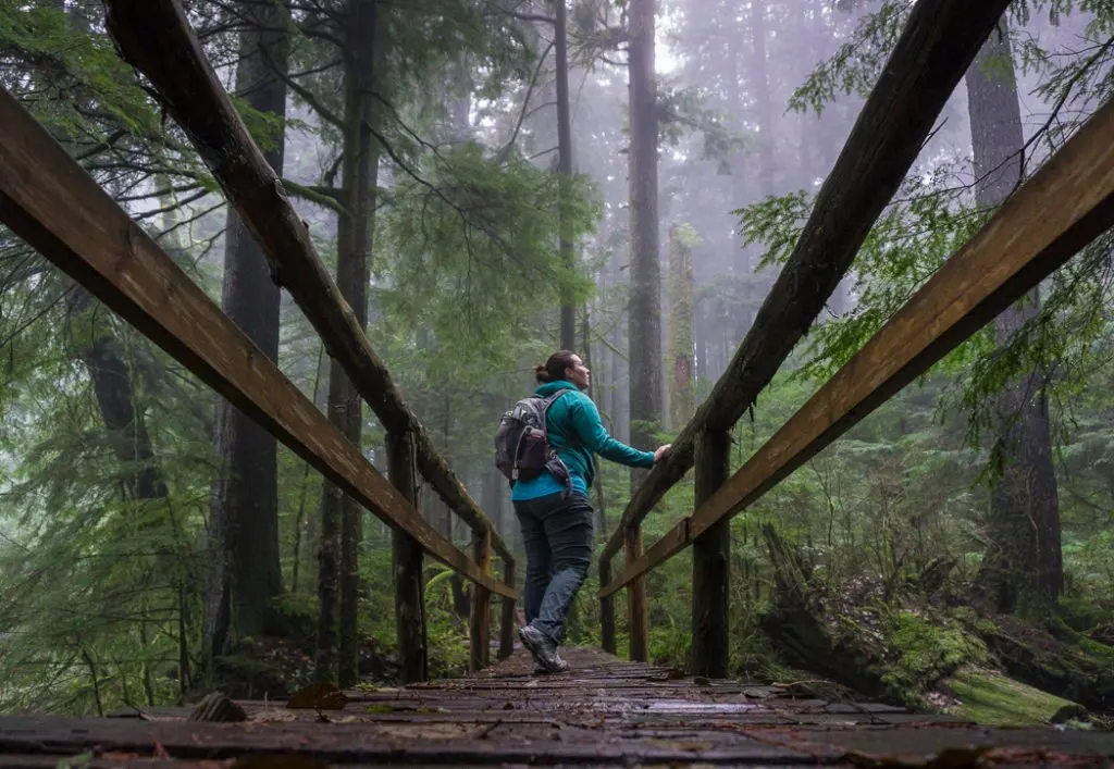 A hiker in the fog. Hiking in bad weather is one way to avoid crowded trails.
