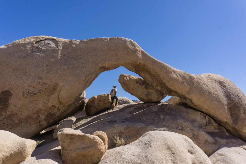 The natural rock arch at Arch Rock in Joshua Tree National Park, one of 15 awesome things to do in Joshua Tree. Add visiting Arch Rock to your Joshua Tree bucketlist.