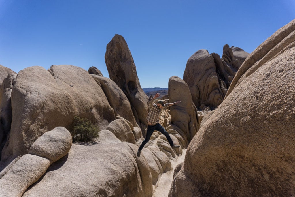 Rock scrambling near Arch Rock in Joshua Tree National Park, one of 15 awesome things to do in Joshua Tree. Add rock scrambling to your Joshua Tree bucketlist.