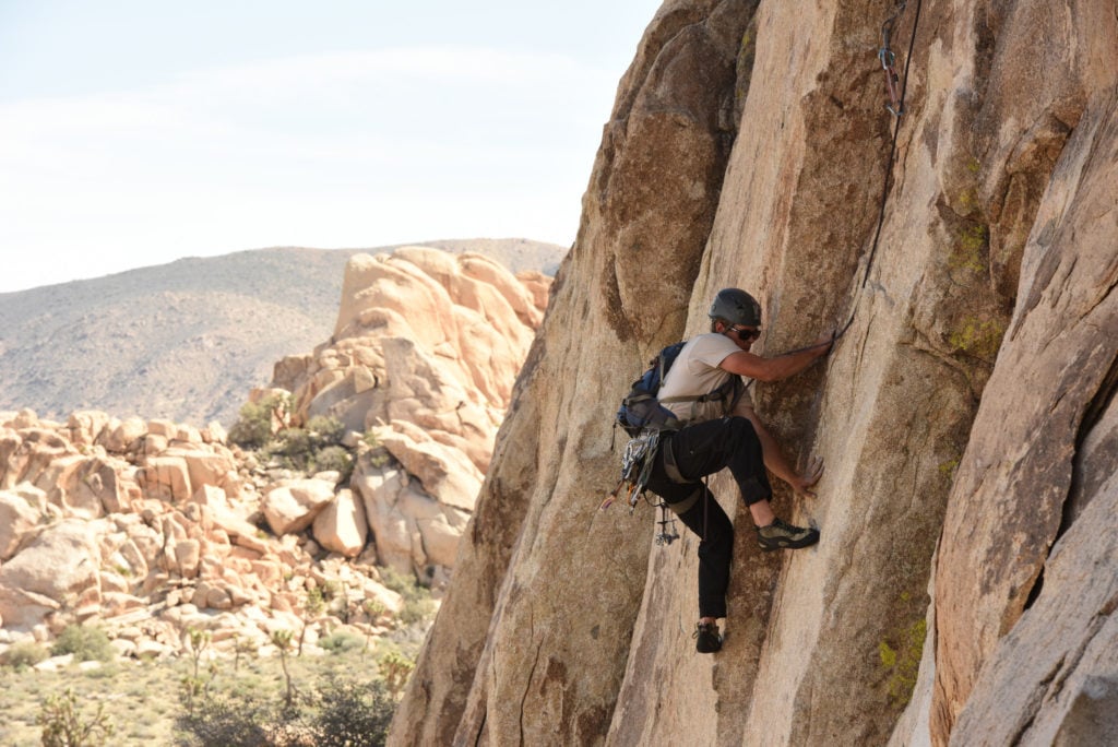 A rock climber in Joshua Tree National Park, one of 15 awesome things to do in Joshua Tree. Add rock climbing (or just watching the rock climbers) to your Joshua Tree bucketlist.