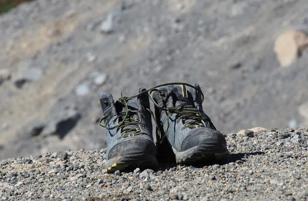 Hiking boots airing out along the trail. Find out how to prevent blisters when hiking, and how to treat blisters on the trail.