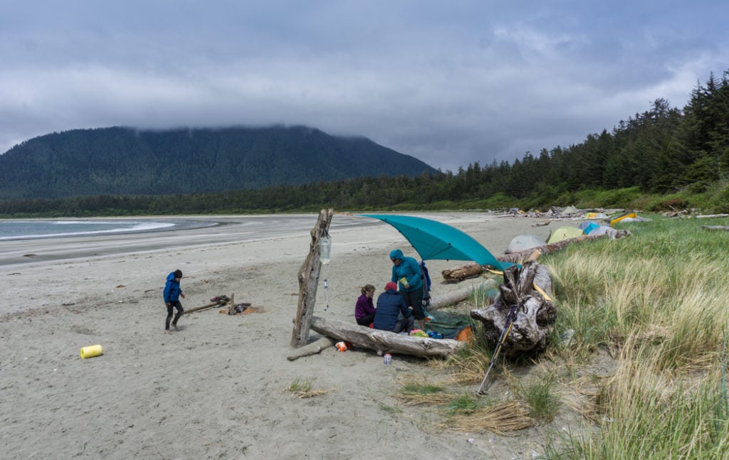 Camp kitchen under a tarp on a beach. How to choose backpacking meals.