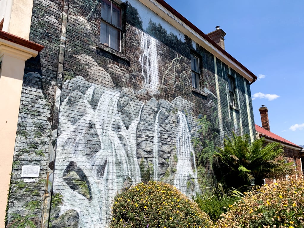 A mural of a waterfall painted on the side of the brick building in the small town of Sheffield, Tasmania