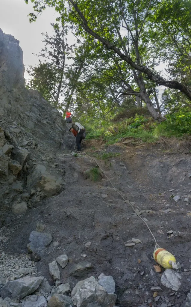 Using a rope to descend from a headland between Third Beach and Toleak Point in Olympic National Park