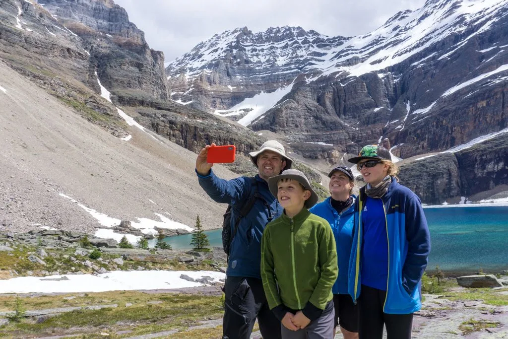 A family takes a selfie at Lake Oesa near Lake O'Hara in Yoho National Park