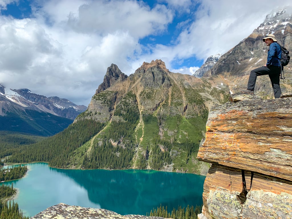 A hiker at Opabin Prospect above Lake O'Hara in Yoho National Park. Find out what to bring to Lake O'Hara with this Lake O'Hara packing list for campers and hikers.