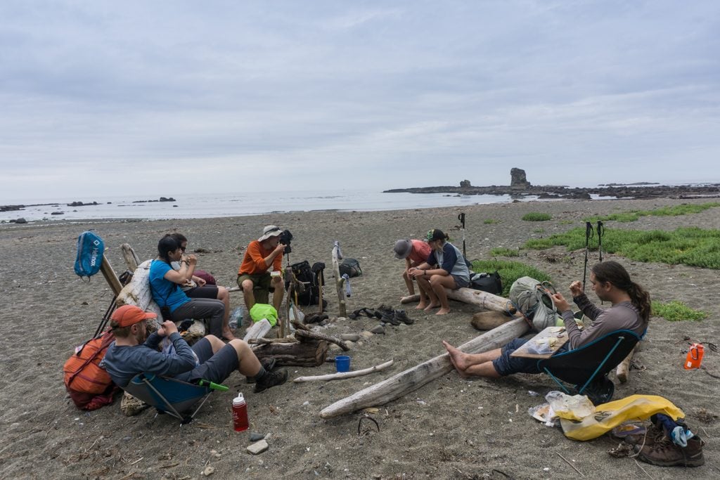 Hikers eating lunch at Bonilla Point on the West Coast Trail