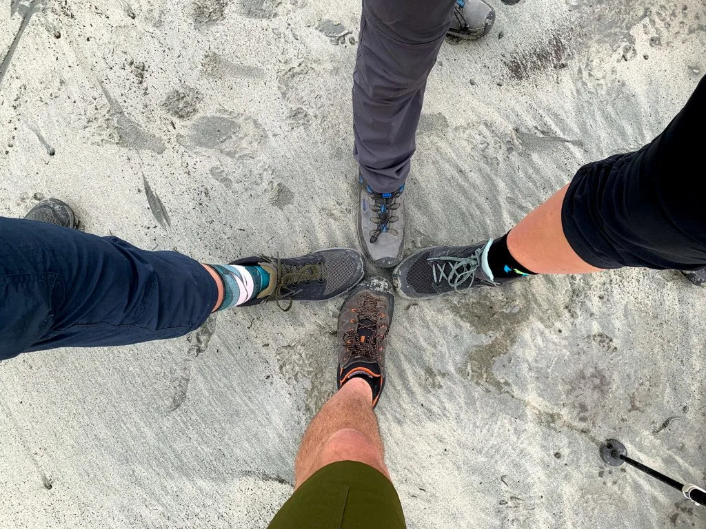 Hikers feet on the beach at Pachena Bay