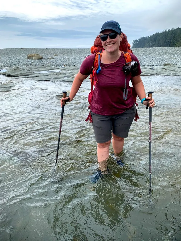 A hiker crossing Walbran Creek on the West Coast Trail