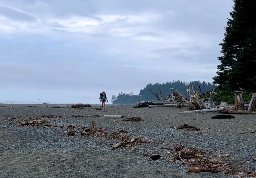 A hiker on the beach at Carmanah River on the West Coast Trail