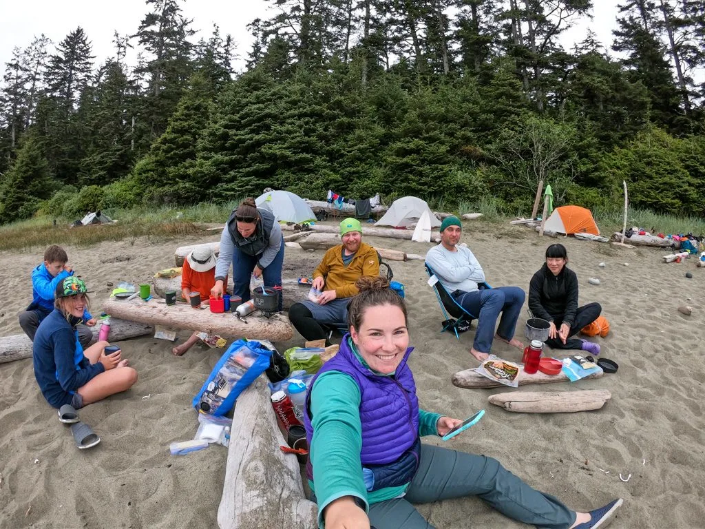 A group of backpackers cooking on the beach