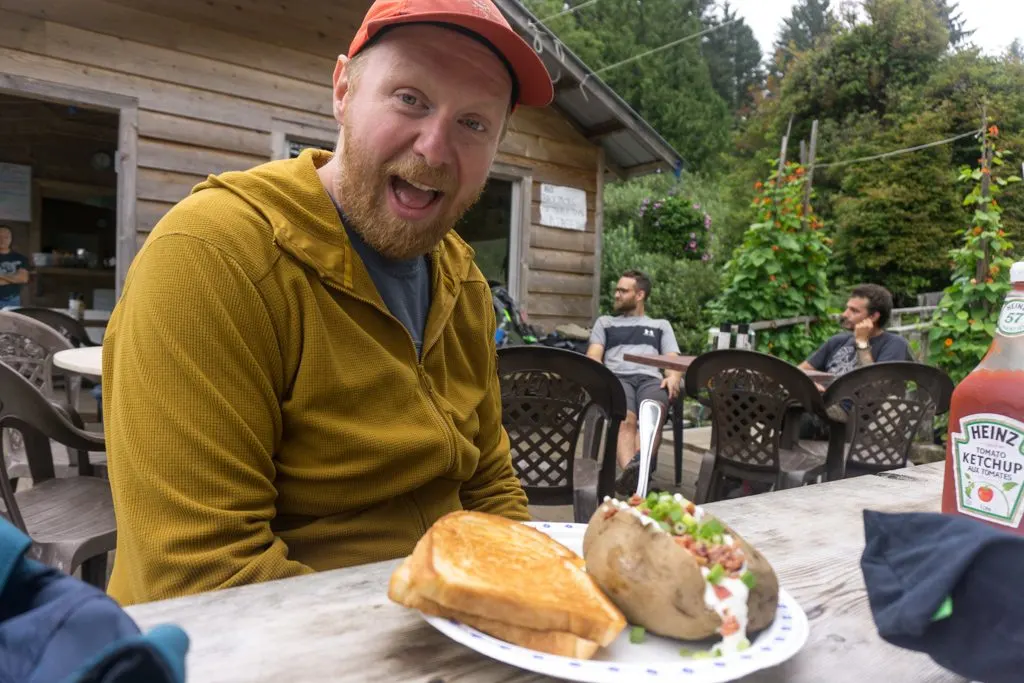 A hiker with a plate of food at The Crab Shack