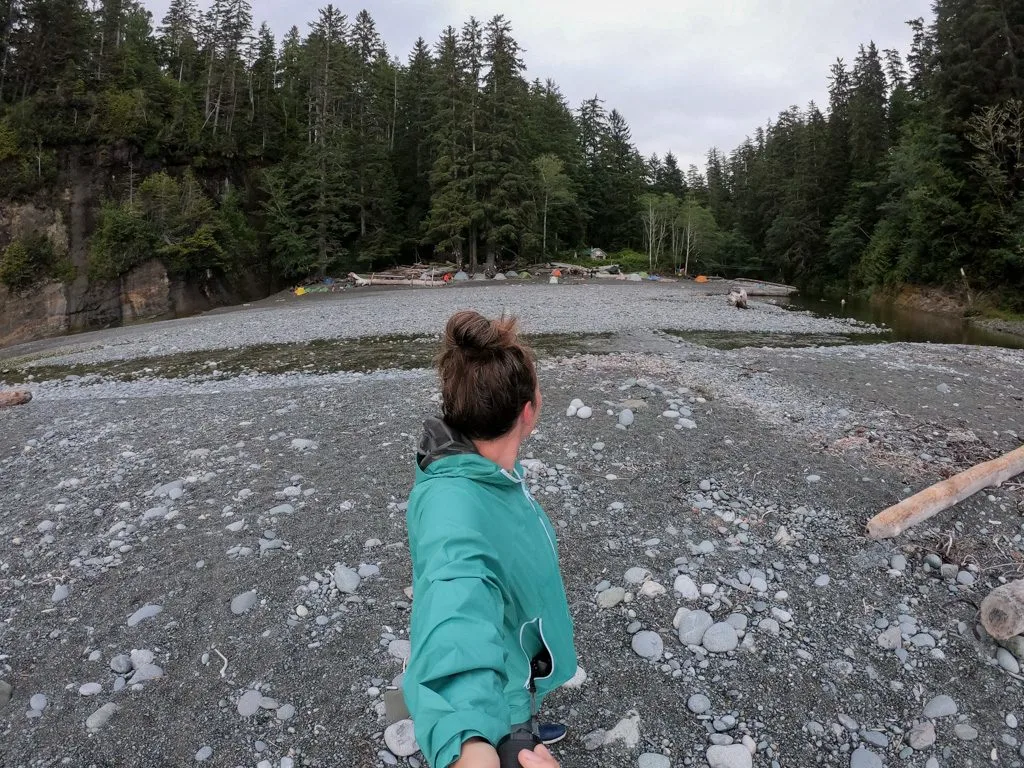 A hiker wearing a rain jacket at Camper Bay on the West Coast Trail