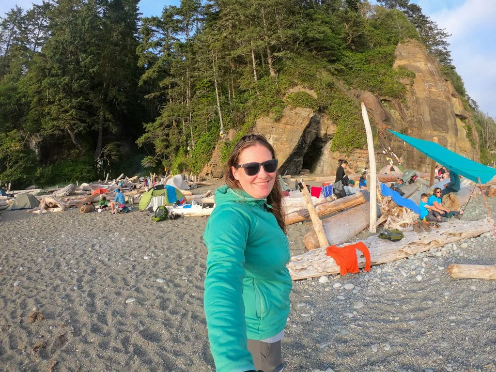 A hiker at a beach campsite on the West Coast Trail. Read these tips for coastal hiking before your trip.