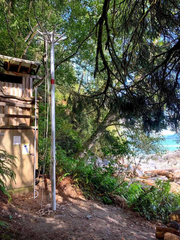 A metal pole for hanging food at a campground on the West Coast Trail