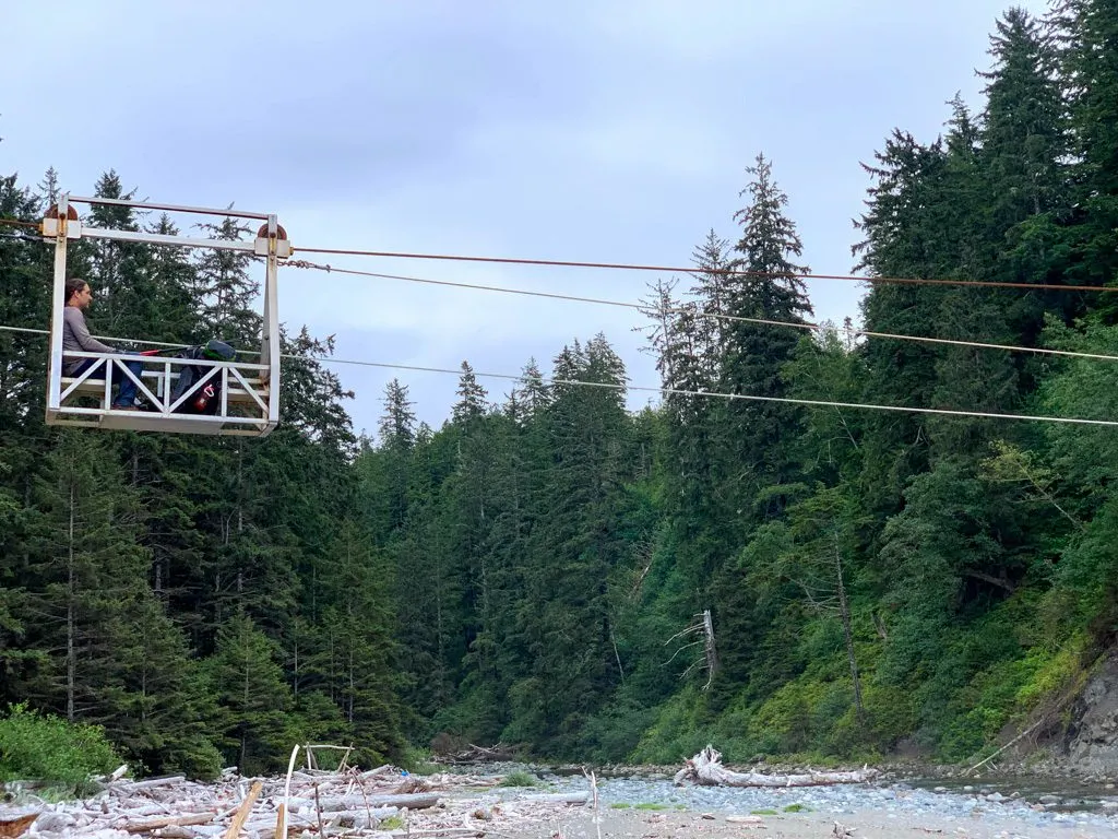A hiker rides the Carmanah cable car on the West Coast Trail