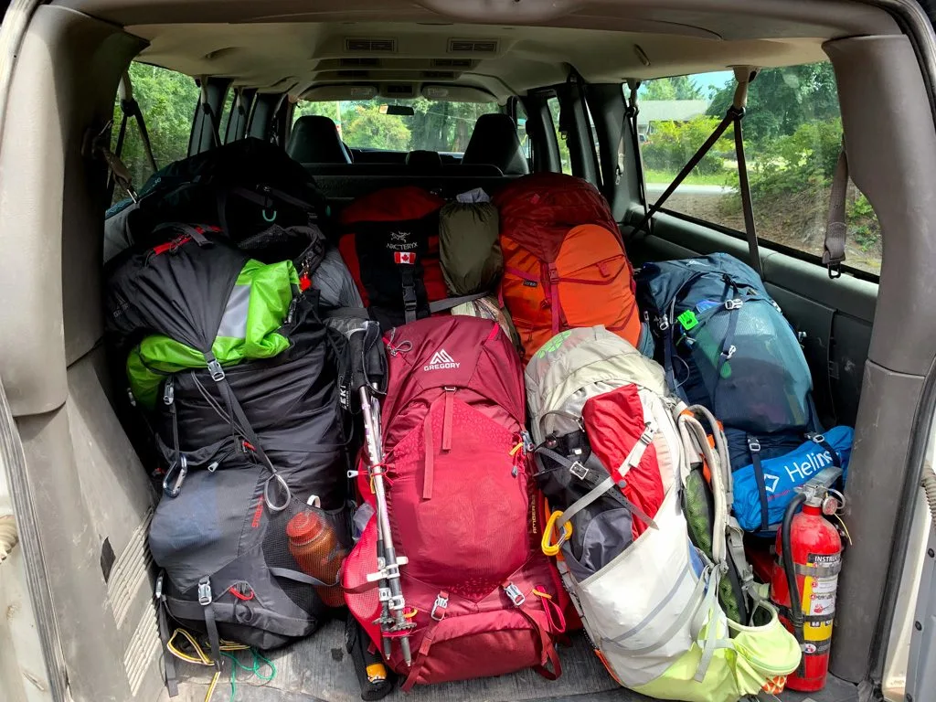 Backpacks in the back of a shuttle ready to go to the West Coast Trail. 