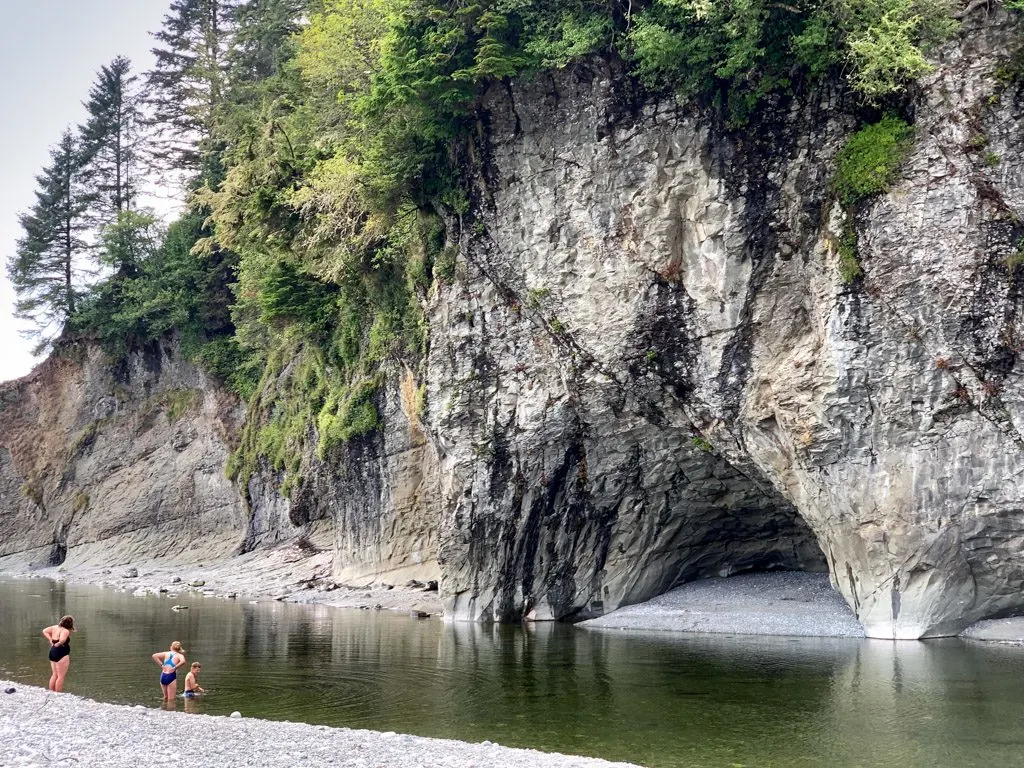 Hikers swimming in Walbran Creek on the West Coast Trail