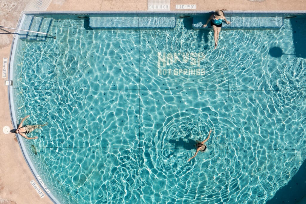 Aerial view of people swimming in the pool at Nakusp Hot Springs. 