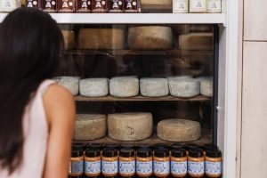 A woman looks into a cheese aging room at the Bruny Island Cheese Co.