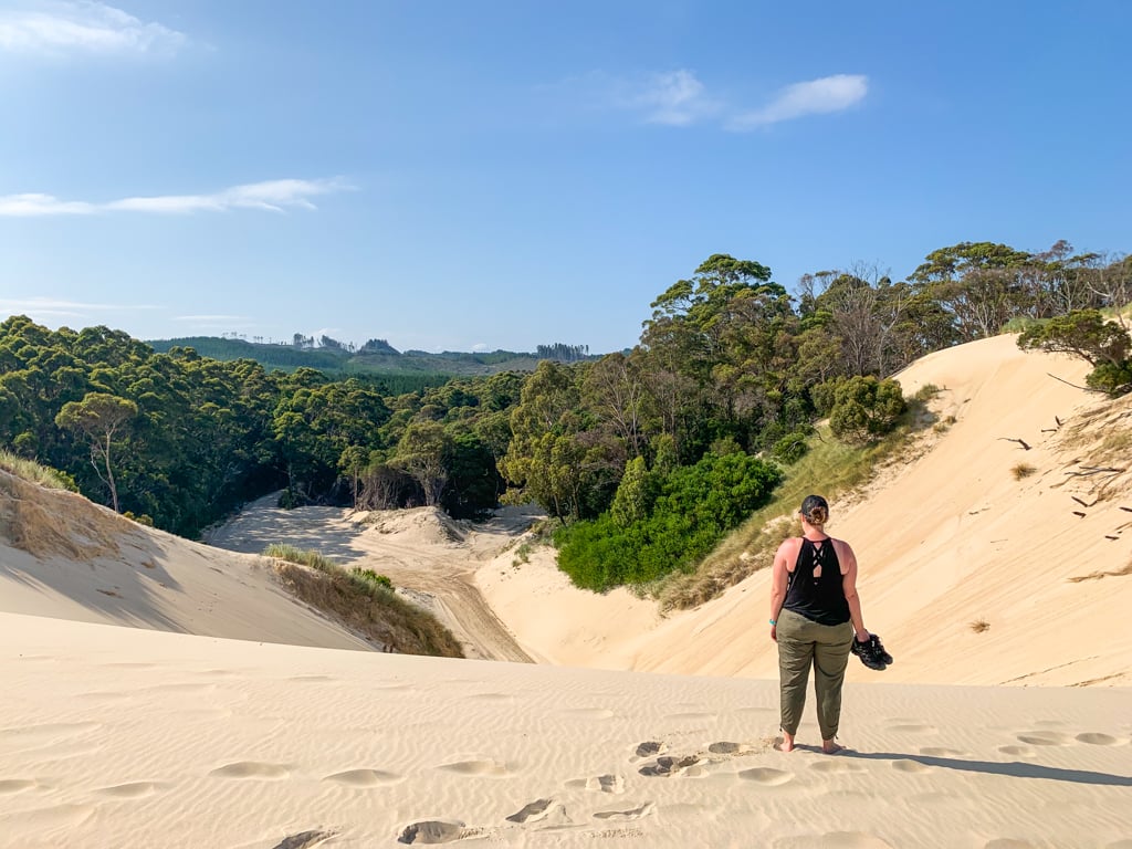 Woman standing on a dune at Henty Dunes in Tasmania
