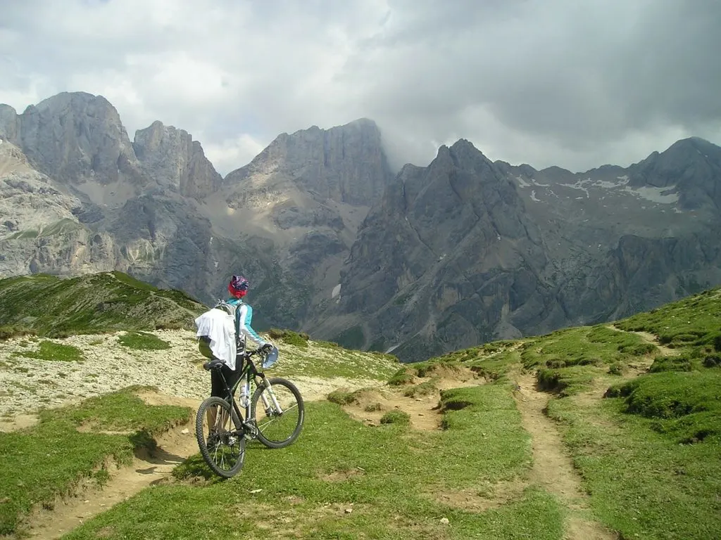 A woman rides a mountain bike in the mountains