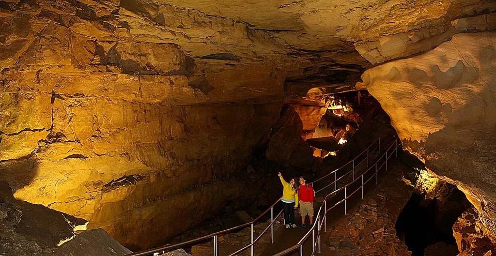 Two people inside the Thanksgiving Hall portion of Mammoth Caves National Park in Kentucky