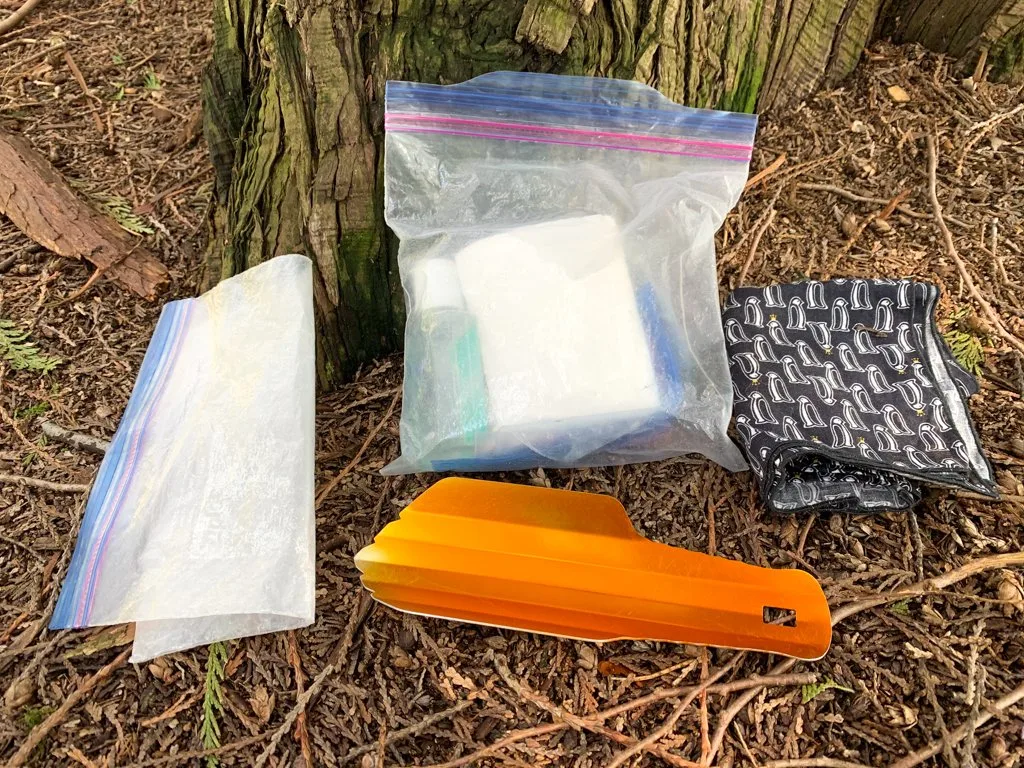 Everything you need to go to the bathroom while hiking: a trowel, toilet paper, hand sanitizer, pee cloth and plastic bag to pack out used toilet paper.