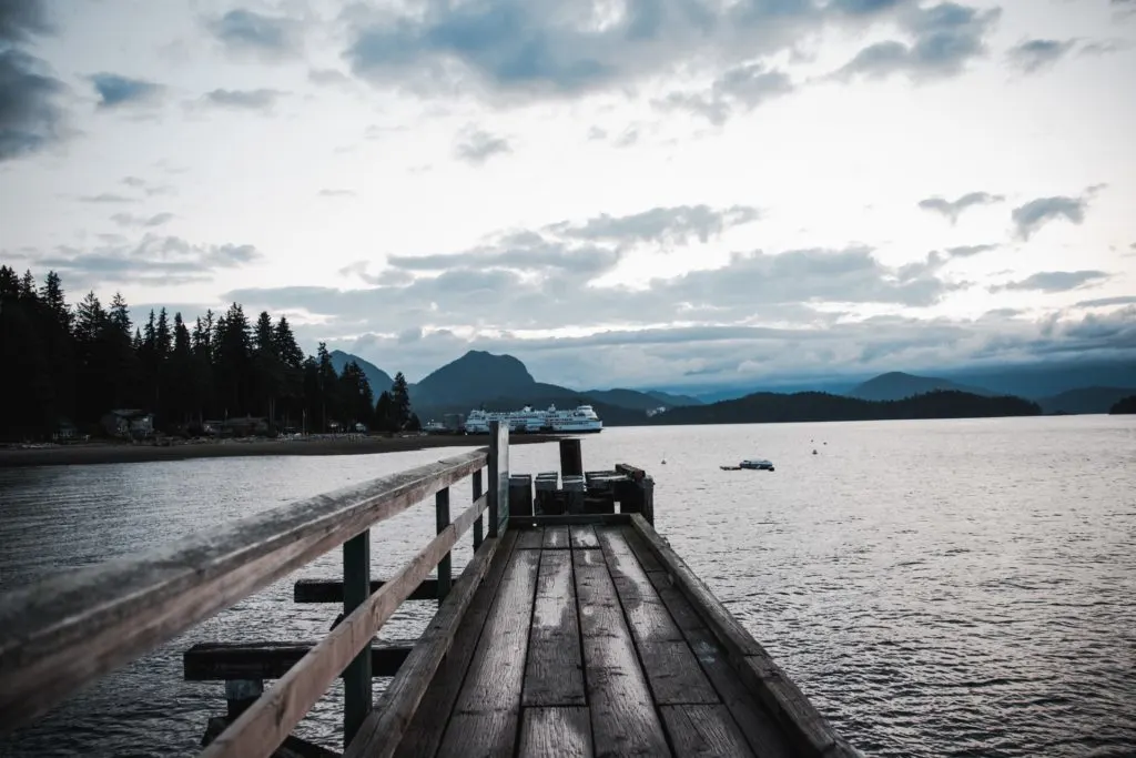 A BC ferry goes past the end of a dock on Bowen Island. It's one of the best weekend getaways from Vancouver