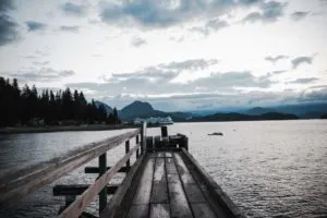 A BC ferry goes past the end of a dock on Bowen Island near Vancouver