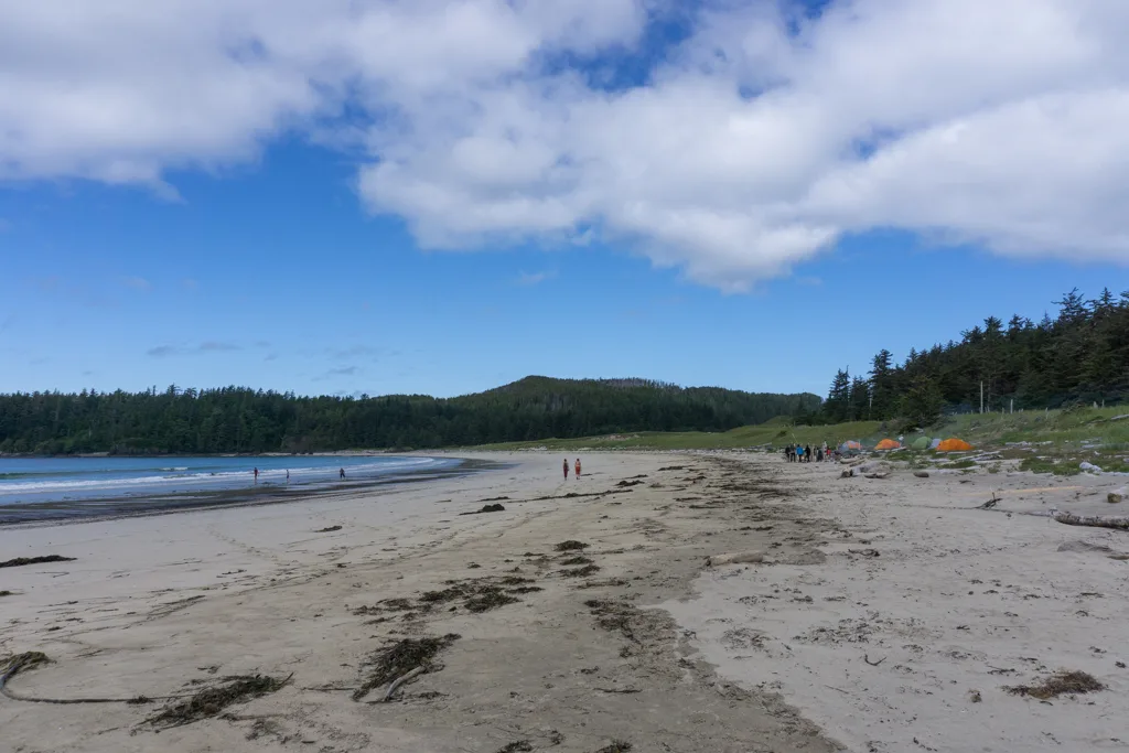 Hikers and campers on the beach at Guise Bay in Cape Scott Provincial Park on North Vancouver Island in British Columbia