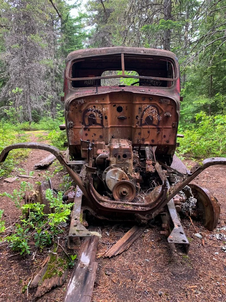 Front view of an abandoned old truck in the forest near Whistler, BC