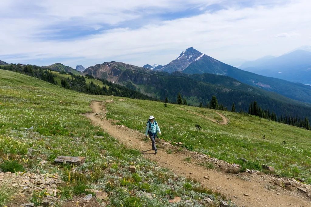 A hiker on the Stoke Climb Trail at Revelstoke Mountain Resort