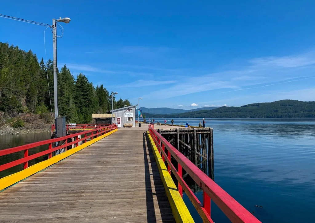 People fish from the pier at Kelsey Bay near the village of Sayward, BC