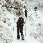 Snowshoers on a snow trail - You need this list of the best gifts for snowshoers