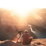 A couple watch the sunset on a hike - get ideas for the most romantic gifts for hikers and campers