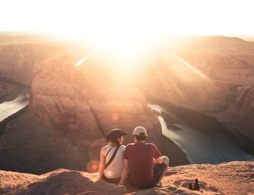 A couple watch the sunset on a hike - get ideas for the most romantic gifts for hikers and campers